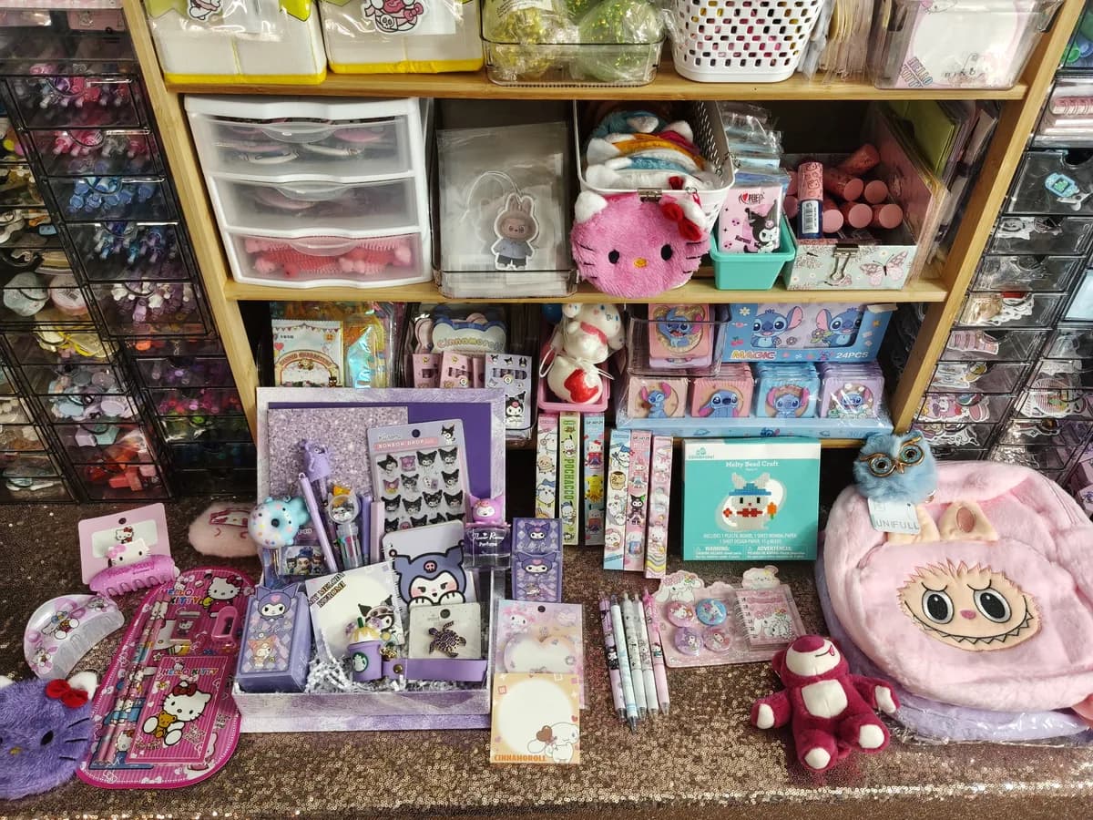 A purple prize basket with craft items, stationery, and soft toys